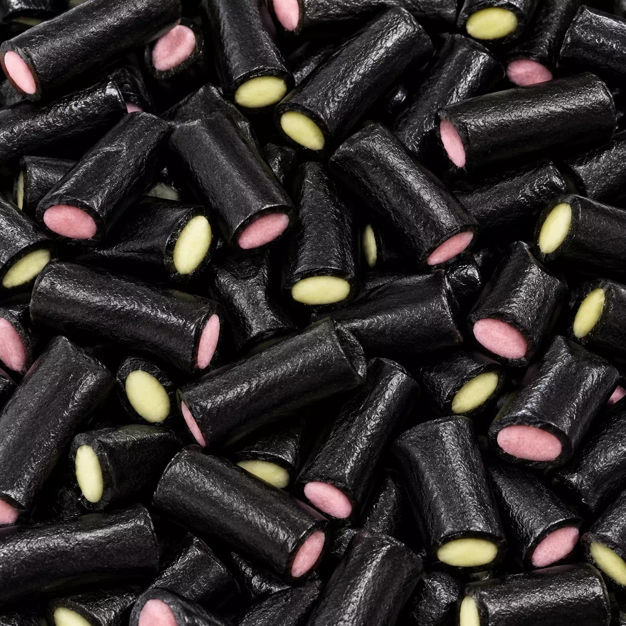 Tronçons de réglisse noire fourrés rose et jaune