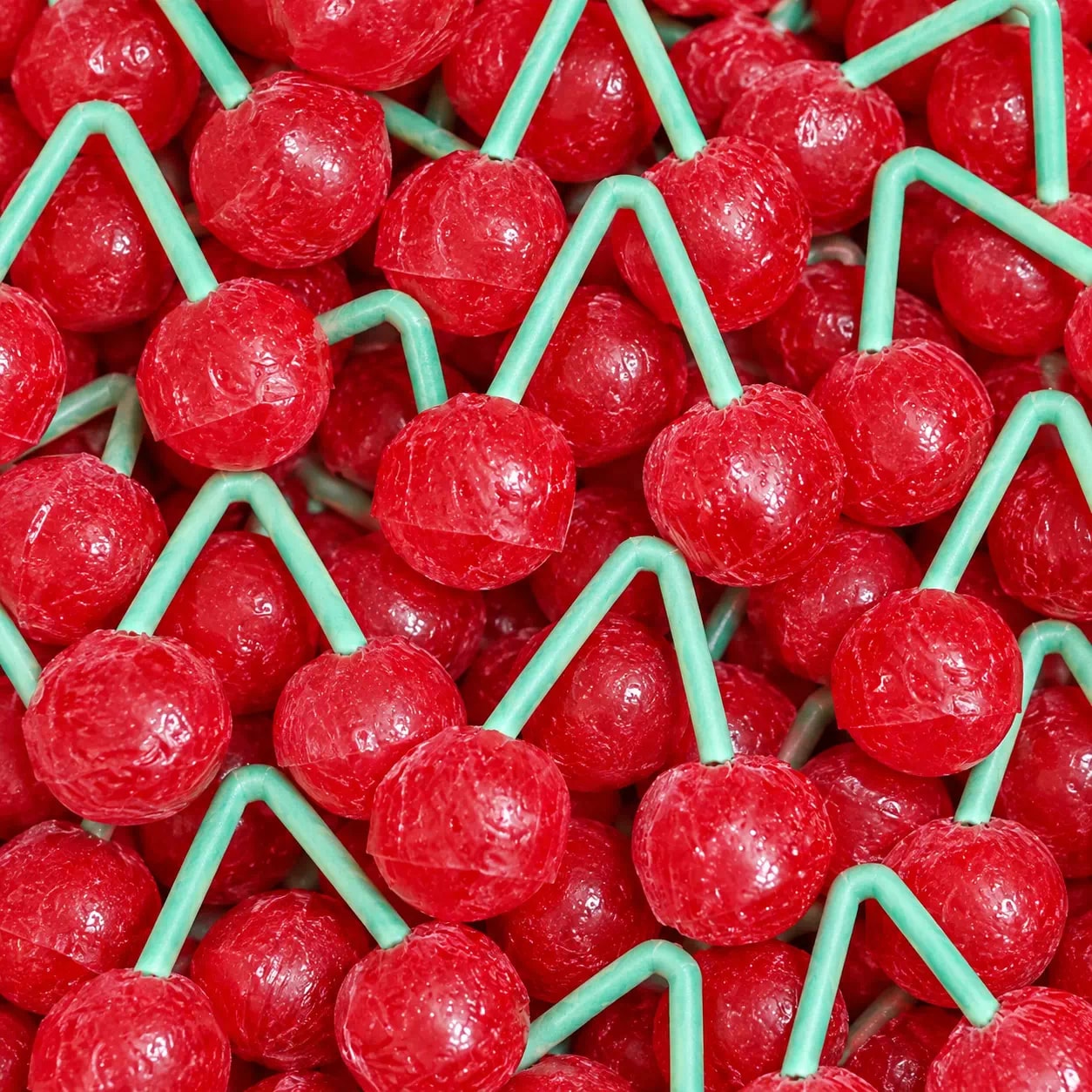Sucettes à deux cerises rouges sur un bâton vert