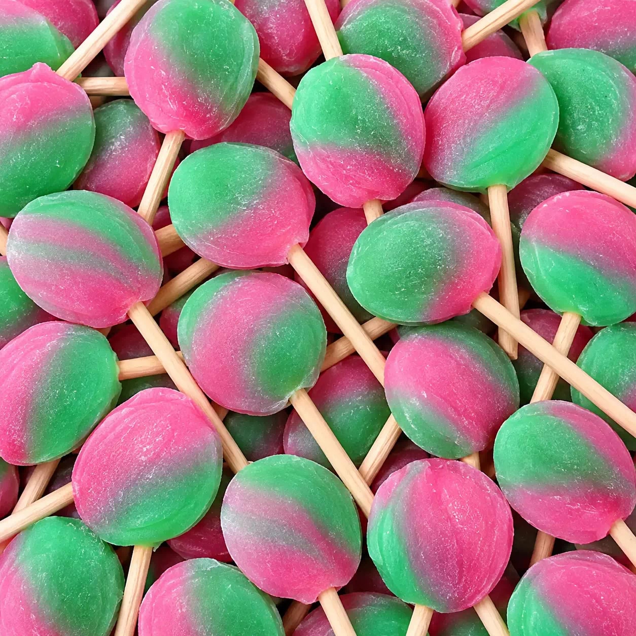 Grandes sucettes plates rose et vert sur bâton de bois